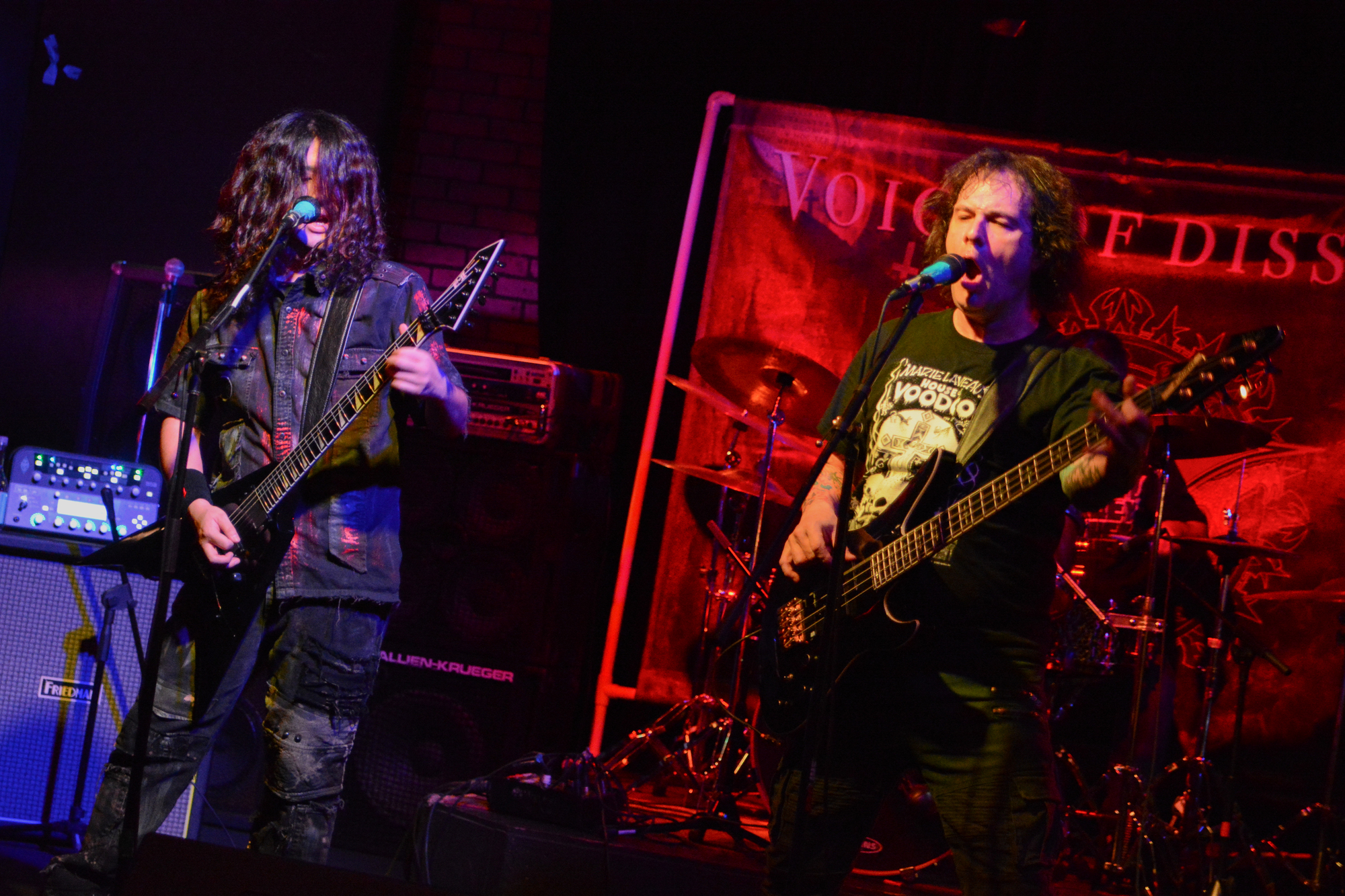 Live performance with guitar, bass, and vocals